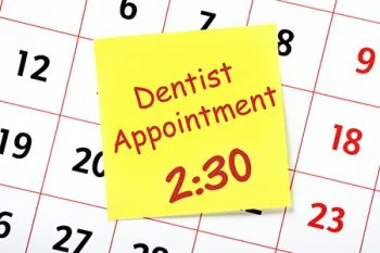 calendar with dentist appointment on a sticky note