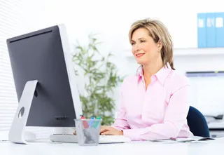 woman using a desktop computer
